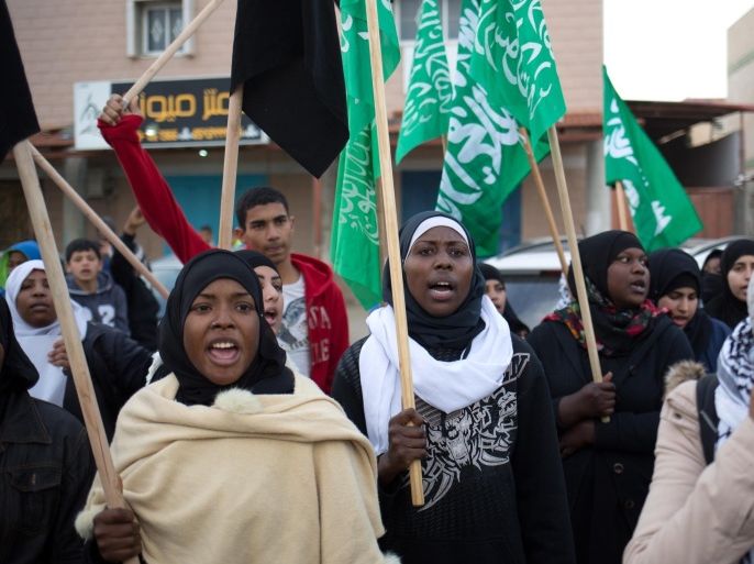 Bedouin women waving Islamic movement flags protest ahead of the funeral of Sami al-Zayadna, 47, in the southern Israeli Bedouin city of Rahat on January 19, 2015. Zayadna died the previous day following clashes with Israeli policemen during the funeral of Sami al-Ajar, 22, another Bedouin who died of a gunshot wound a week earlier during a police drug raid on the Negev Bedouin town. Leaders of Israel's 1.7 million Arabs declared a general strike on January 20, 2015 throughout the country in protest at the recent deaths of the two Bedouin men in confrontations with Israeli police. AFP PHOTO/MENAHEM KAHANA