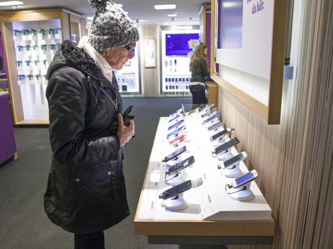 An elderly female customer inspects smartphones on display inside a Telia mobile phone store, operated by TeliaSonera AB, in Stockholm, Sweden, on Thursday, Jan. 29, 2015. TeliaSonera AB reported earnings that missed analysts' estimates and forecast that 2015 profit won't grow as Sweden's biggest phone carrier faces widening competition in Nordic and Baltic markets and economic challenges in Eurasia.
