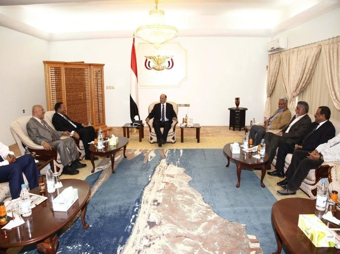 Yemen's President Abd-Rabbu Mansour Hadi (C) meets with politicians at the Republican Palace in the southern port city of Aden February 26, 2015. Yemen's dominant Houthi group said on Tuesday that Hadi had lost his legitimacy as head of state and he was being sought as a fugitive from justice. REUTERS/Stringer (YEMEN - Tags: CIVIL UNREST POLITICS)
