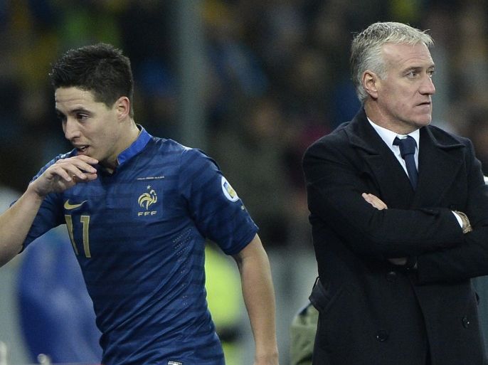 France's midfielder Samir Nasri (L) leaves the pitch next to France's head coach Didier Deschamps during the FIFA World Cup 2014 qualifying football match Ukraine vs France on November 15, 2013 at the Olympic stadium in Kiev. AFP PHOTO / FRANCK FIFE