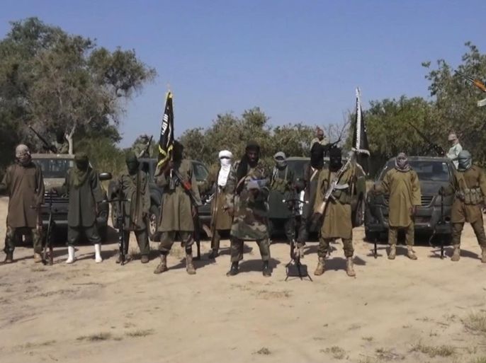 FILE - In his file image taken from video released late Friday evening, Oct. 31, 2014, by Boko Haram, Abubakar Shekau, centre, the leader of Nigeria's Islamic extremist group denies agreeing to any cease-fire with the government and says more than 200 kidnapped schoolgirls all have converted to Islam and been married off. Boko Haram leader Abubakar Shekau Tuesday Jan. 20, 2015 claimed responsibility for the mass killings in the northeast Nigerian town of Baga and threatened more violence. As many as 2,000 civilians were killed and 3,700 homes and business were destroyed in the Jan. 3, 2015, attack on the town near Nigeria’s border with Cameroon, said Amnesty International. (AP Photo/Boko Haram,File)