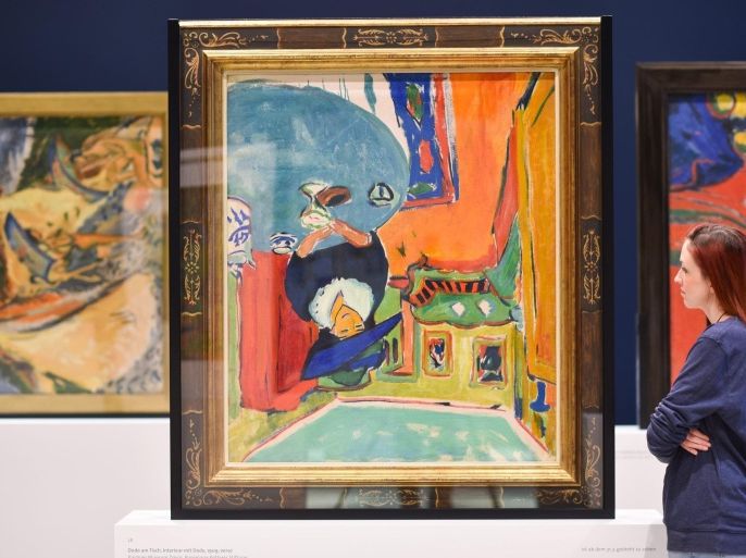 A woman stands looking at the painting 'Interior with Dodo' (1909) by German painter Ernst Ludwig Kirchner displayed at the exhibition 'The Double Kirchner' at the Kunsthalle in Mannheim, Germany, 5 February 2015. The exhibition runs from 06 February to 31 May.