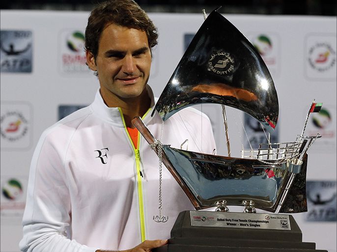 Roger Federer of Switzerland poses with the ATP Dubai Duty Free Tennis Championships trophy after defeating World number one Novak Djokovic of Serbia during their final match on the fifth day of the ATP Dubai Duty Free Tennis Championships on February 28, 2015 in Dubai. AFP PHOTO / KARIM SAHIB