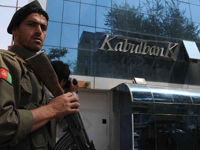 An Afghan security guard keeps watch in front of the Kabul Bank in Kabul on September 1, 2010. Afghanistan's central bank governor said that the country's biggest bank, Kabul Bank was in no danger of collapse following allegations of corruption in the US media.