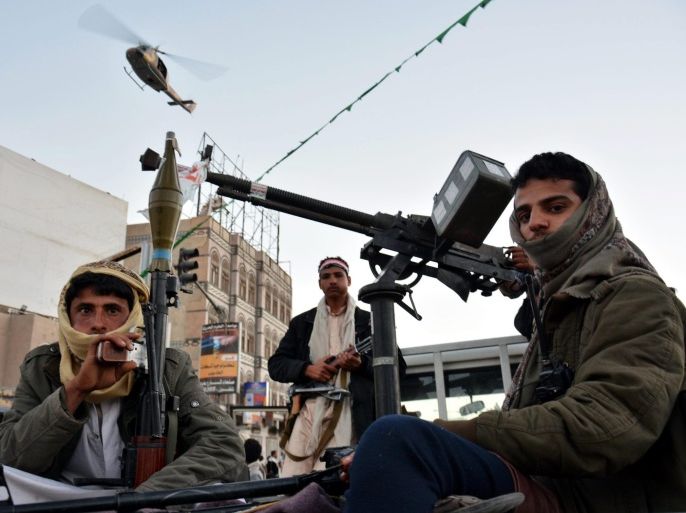 A Yemeni army helicopter patrols from the sky as heavily armed members of the Houthi militia stand watch over a rally commemorating the fourth anniversary of the 2011 uprising and celebrating the Houthis takeover in Sanaa, Yemen, 11 February 2015. Reports state thousands of Houthi supporters took to streets of Sanaa commemorating the 2011 protesters that led to the downfall of the regime of the former Yemeni President Ali Abdullah Saleh, while at the same time in other Yemeni cities many marched in protest of the Houthi takeover of Sana'a and other areas of the country.