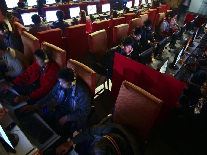 FILE - In this March 12, 2010 file photo, people use computers at an Internet cafe in Fuyang, in central China's Anhui province. The number of online microblog users in China dropped by more than 27.8 million in 2013, marking the first major decline in popularity of a social media genre that has offered a way to share unfiltered information in a country with strict controls, China Internet Network Information Center said in an annual report Thursday, Jan. 17, 2014. (AP Photo/File)