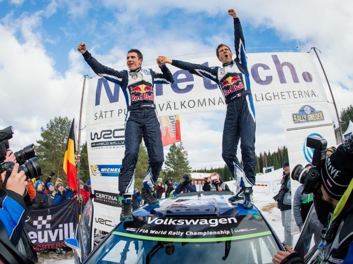 Sebastien Ogier of France (R) and his co-driver Julien Ingrassia celebrate on their Volkswagen Polo R WRC after winning Rally Sweden, second round of the FIA World Rally Championship on February 15, 2015 in Hagfors, Sweden. AFP PHOTO/JONATHAN NACKSTRAND