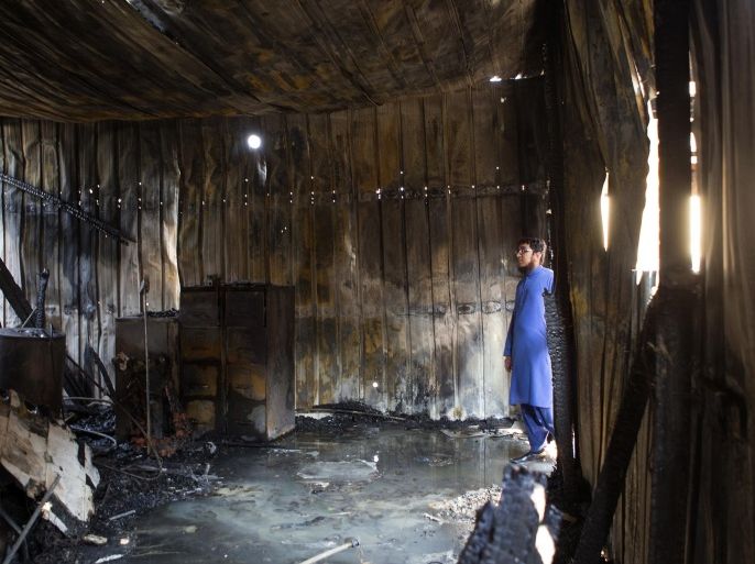 Ahsan Zahid, Assistant Imam, assistant priest in Islam, looks at the charred Quba Islam Institute after a fire on Friday, Feb. 13, 2015, in Houston. The Houston Fire Department says nobody was hurt in the fire around 5:30 a.m. Friday at the Quba Islamic Institute. Authorities are trying to determine what caused the blaze in a rear part of the structure. (AP Photo/Houston Chronicle, Cody Duty) MANDATORY CREDIT