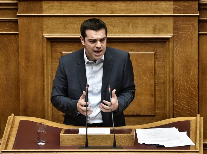 Greek Premier Alexis Tsipras addresses the parliament during his policy speech in Athens on February 8, 2015. New Greek Prime Minister Alexis Tsipras said on February 8 that Greece did not want an extension of its bailout but a 'bridge programme' which would buy the country time to negotiate a new deal. AFP PHOTO / ARIS MESSINIS