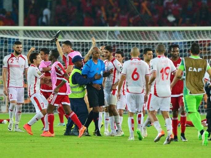 Referee Rajindraparsad Seechurn is escorted off the field by security personal as Tunisian players confront him after his decision to award a penalty to Equatorial Guinea during the 2015 Africa Cup of Nations quarterfinal football match between Tunisia and Equatorial Guinea at Bata Stadium, Bata, Equatorial Guinea on 31 January 2015. EPA/GAVIN BARKER UK AND IRELAND OUT