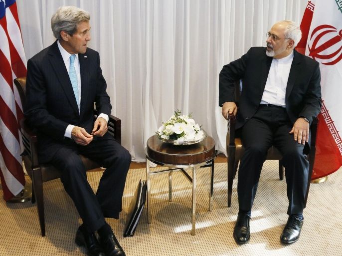 U.S. Secretary of State John Kerry, left, waits with Iranian Foreign Minister Mohammad Javad Zarif before a meeting in Geneva, Switzerland Wednesday, Jan. 14, 2015. Zarif said on Wednesday that his meeting with Kerry was important to see if progress could be made in narrowing differences on his country's disputed nuclear program. (AP Photo/Rick Wilking, Pool)
