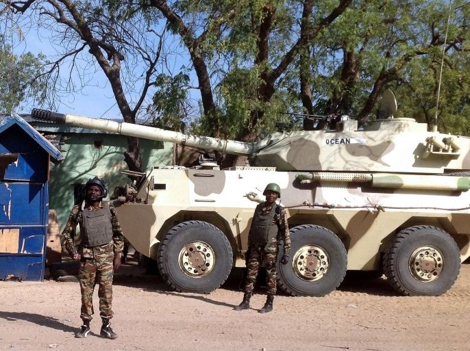 Cameroon's soldiers patrol near a tank in the Cameroonian town of Fotokol, on the border with Nigeria, on February 3, 2015. Boko Haram fighters killed nearly 70 civilians and six soldiers in Fotokol on February 4, 2015, a Cameroonian security source told AFP. The attack came a day after Chad sent troops across the border to flush the jihadists out of the Nigerian town of Gamboru, which lies some 500 metres (yards) from Fotokol on the other side of a bridge.AFP PHOTO / STEPHANE YAS