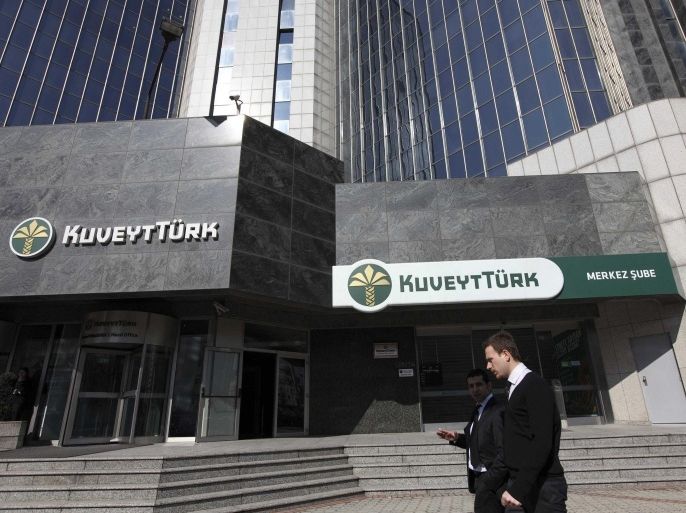 People walk past the Kuveyt Turk head office in Istanbul February 21, 2012. Turkey's government plans its first-ever issue of Islamic bonds this year, overcoming sensitivities about Islamic finance in the secular republic as it seeks to tap a rich pool of investors flush with oil money. A sovereign sukuk issue from an economy regarded as one of the most progressive and successful in the Muslim world would signal intent on Turkey's part to play a bigger role in Islamic finance. The size of the global sukuk market is estimated at more than $100 billion. Picture taken February 21, 2012.
