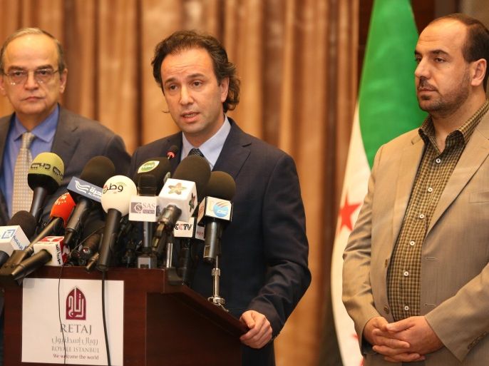 In this picture taken on January 5, 2015, released by the Syrian National Coalition Media Office, Khaled Khoja, the head of the Syrian National Coalition, center, speaks during a press conference, as the former Secretary General Nasr Hariri, right, and the former president Hadi Bahra, left, stand next to him, in Istanbul, Turkey. A Russian initiative to host peace talks this month between the Syrian government and its opponents appears to be unraveling, as prominent Syrian opposition figures shun the planned negotiations over concerns that the framework is flawed and holds little chance of success. (AP Photo/The Syrian National Coalition Media Office)