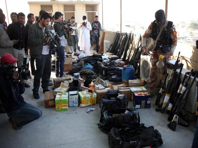 Pakistani Rangers show arms seized during a raid at Nine-Zero, the headquarters of Mutahida Qaumi Movement (MQM), in Karachi, Pakistan, 11 March 2015. According to media reports more than two dozens suspects were arrested, huge quantity of arms recovered during a raid at Nine-Zero, the headquarters of Mutahida Qaumi Movement (MQM) on 11 March. Karachi, a city of more than 18 million people and country's financial hub has seen a a big rise in ethnic-, sectarian- and political-related violence in recent months that has claimed hundreds of lives.