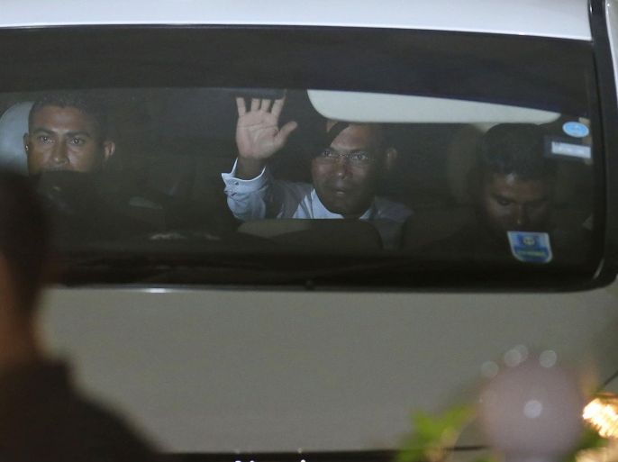 In this Friday, March 13, 2015 photo, former president of Maldives Mohamed Nasheed waves to reporters outside the court after a three-judge panel pronounced his verdict in Male', Maldives. Nasheed was convicted and sentenced to 13 years in prison after a quick and disputed trial that raised fears of more instability in the Indian Ocean nation. Nasheed's defense lawyers pulled out of the case in the middle of the trial, accusing the court of rushing the hearings and not allowing them enough time to prepare. (AP Photo/Sinan Hussain)