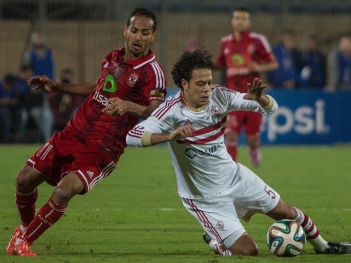 CAIRO, EGYPT - JANUARY 29: Walid Soliman (C) of AL Ahly vies for the ball with Ebrahim Salah (R) of Zamalek during a football match between Al Ahly and Zamalek during Egyptian Premiere League Cup at 30 June Air Defense Stadium in Cairo, Egypt on January 29, 2015.