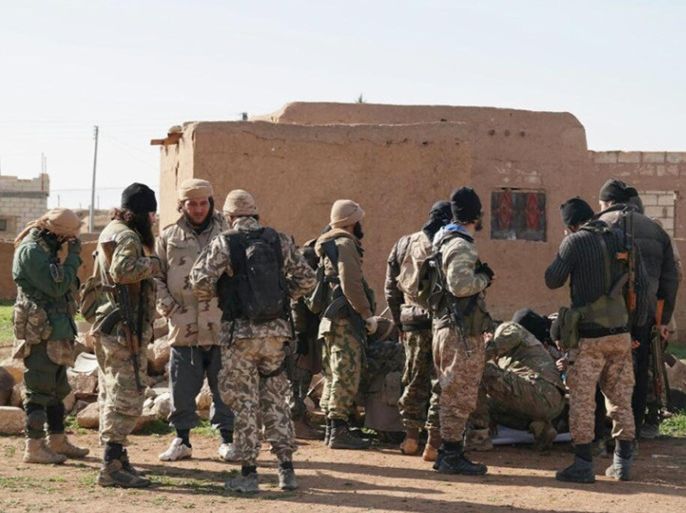 In this image posted on a militant social media account by the Al-Baraka division of the Islamic State group on Tuesday, Feb. 24, 2015, militants take a break during fighting in Tal Tamr, Hassakeh province, Syria. Fierce fighting between Kurdish and Christian militiamen and Islamic State militants is continuing on Wednesday, Feb. 25 in northeastern Syria where the extremist group recently abducted at least 70 Christians. (AP Photo via militant social media account)