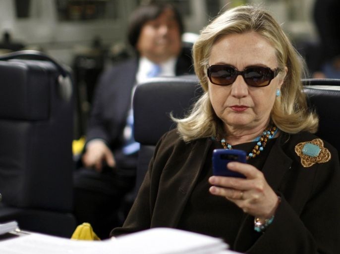 Former U.S. Secretary of State Hillary Clinton checks her PDA upon her departure in a military C-17 plane from Malta bound for Tripoli, Libya, in this October 18, 2011, file photo. An investigative committee in the U.S. House of Representatives will subpoena Clinton's personal emails regarding the 2012 attack on the U.S. consulate in Benghazi, Libya, the Washington Post reported on March 4, 2015. REUTERS/Kevin Lamarque/Files (LIBYA - Tags: POLITICS)