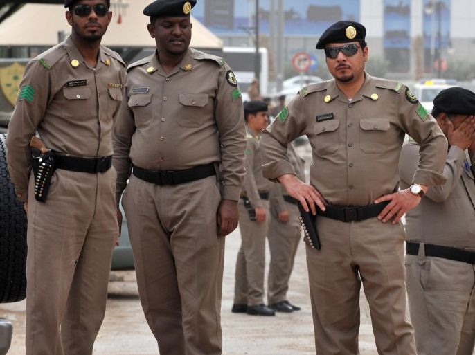 Saudi policemen stand guard in front of the 'Public grievances Department' building in Riyadh on March 11, 2011 as Saudi Arabia launched a massive security operation in a menacing show of force to deter protesters from a planned 'Day of Rage' to press for democratic reform in the kingdom.