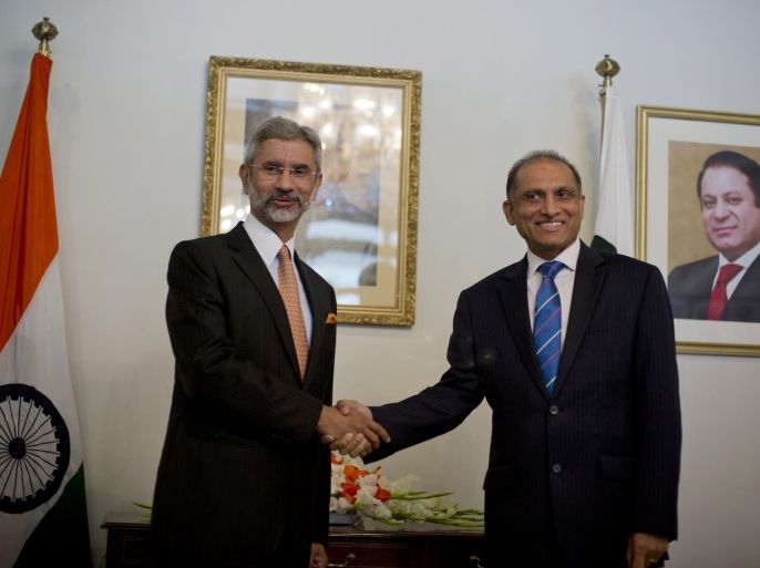 Indian Foreign Secretary Subrahmanyan Jaishankar, left, poses for photographers, as he shakes hands with his Pakistani counterpart Aizaz Chaudhry at the foreign ministry in Islamabad, Pakistan, Tuesday, March 3, 2015. India's foreign secretary has arrived in Pakistan on a two-day visit, marking the first high-level meeting since talks broke down between the two nuclear-armed rivals last year. (AP Photo/B.K. Bangash)