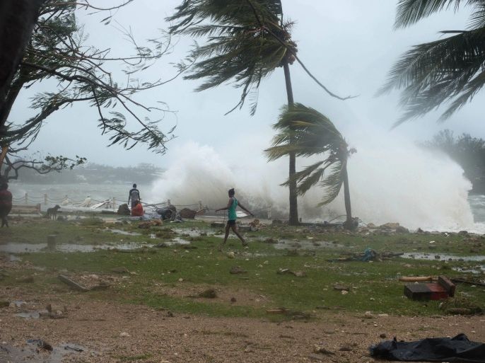 A handout photo provided by UNICEF Pacific on 14 March 2015 of people walking along a seaside with waves splashing on land on Vanuatu island, South Pacific region, 14 March 2015. Tropical Cyclone Pam reportedly claimed at least five lives 14 March in the South Pacific and the toll was feared to climb from one of the strongest such storms on record. The cyclone ripped its way through an area dotted with islands, bringing powerful winds, heavy rain and rough seas. Vanuatu Island appeared to be hardest hit as the cyclone was slowly tracking south-south-east towards New Zealand. EPA/GRAHAM CRUMB / UNICEF PACIFIC / HANDOUT