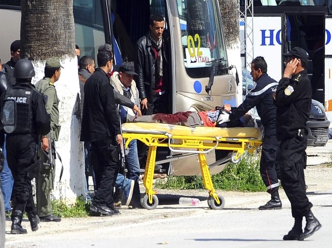 A victim is being evacuated from the Bardo museum are evacuated in Tunis, Wednesday, March 18, 2015 in Tunis, Tunisia after gunmen opened fire at the leading museum in Tunisia's capital. Tunisia's prime minister says 21 people are dead after an attack on a major museum, including 17 foreign tourists ó and that two or three of the attackers remain at large. (AP Photo/Hassene Dridi)