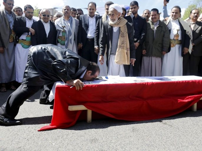 A friend of journalist Abdul Kareem al-Khaiwani kisses his coffin during his funeral procession in Sanaa March 24, 2015. Assailants on a motorbike last week shot dead Khaiwani, one of Yemen's top journalists who is also an activist close to the country's dominant Houthi group, police sources said. REUTERS/Khaled Abdullah