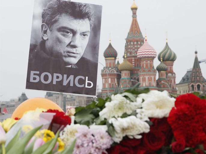 A portrait of murdered Russian opposition veteran leader Boris Nemtsov above flowers tributed in his memory at the site of his killing, with St. Basil's Cathedral seen in the background, in central Moscow, Russia, 02 March 2015. Boris Nemtsov was shot dead late in the evening of 27 February while walking on the Bolshoy Kammeny bridge near the Kremlin. The funeral will be held in Moscow on 03 March 2015.