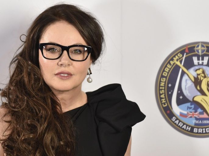 British soprano Sarah Brightman poses for photographs after speaking about her travel to the International Space Station, at a news conference in central London March 10, 2015. After a stellar career ranging from disco hit "I lost my heart to a Starship Trooper" to global success in "Phantom of the Opera", Brightman will blast off into space on September 1 having paid U.S. $52 million (35 million British pounds) for her ticket. REUTERS/Toby Melville (BRITAIN - Tags: ENTERTAINMENT SCIENCE TECHNOLOGY)