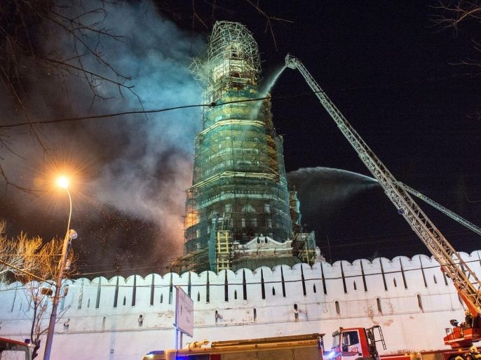 Russian firefighters are at work to extinguish a fire which broke out in Novodevichy Convent bell tower in central Moscow, on March 15, 2015. Novodevichy Convent was founded in 1524. AFP PHOTO / ALEXANDER UTKIN