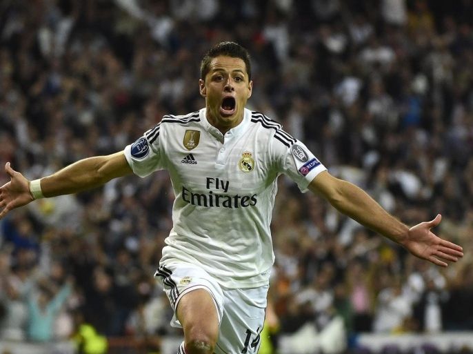 Real Madrid's Mexican forward Javier Hernandez celebrates after scoring a goal during the UEFA Champions League quarter-finals second leg football match Real Madrid CF vs Club Atletico de Madrid at the Santiago Bernabeu stadium in Madrid on April 22, 2015. AFP PHOTO / PIERRE-PHILIPPE MARCOU