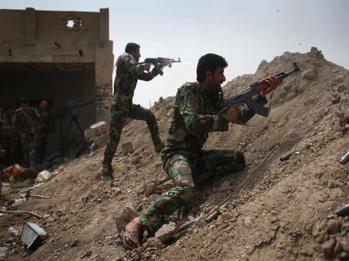EBRAHIM BEN ALI, IRAQ - APRIL 11: Volunteers from the Shia Badr Brigade militia fire on ISIS fighters on the frontline on April 11, 2015 in Ebrahim Ben Ali, in Anbar Province, Iraq. Shia militia and Iraqi government troops are preparing for an assault on ISIS forces in Anbar, much of which was captured by ISIS forces last year. Anbar Province was the site of the some of the fiercest fighting between U.S. and insurgent forces before American troops withdrew in 2010.
