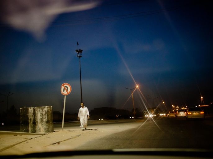 MISRATA, LIBYA - SEPTEMBER 02: A man walks along a stretch of road on September 02, 2011 on the outskirts of Misrata, Libya. The National Transitional Council (NTC) have vowed to tackle shortages of water, fuel and medicines in nearby Tripoli which the UN says are threatening lives.
