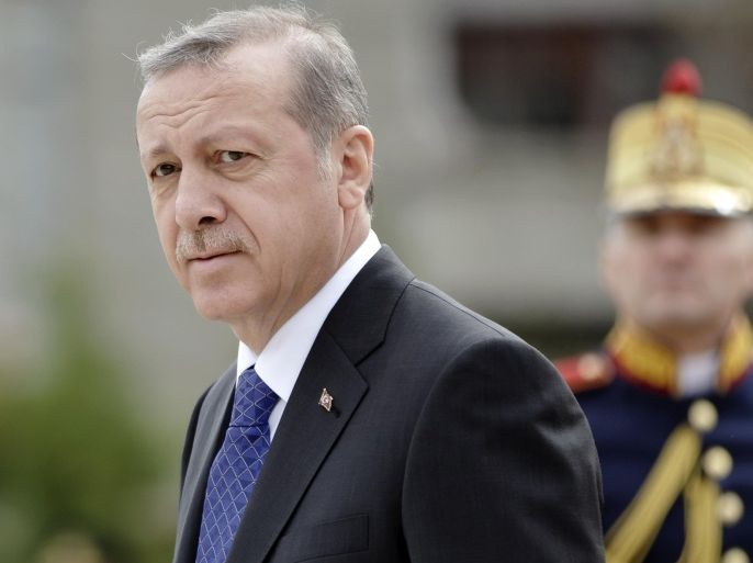 Turkish President Recep Tayyip Erdogan walks by an honor guard at the Cotroceni presidential palace in Bucharest, Romania, Wednesday, April 1, 2015. In istanbul, Turkey on Tuesday two members of a banned leftist group and a prosecutor they held hostage inside a courthouse, after a shootout between the hostage takers and police, officials said. Erdogan is on an official visit to Romania.(AP Photo/Vadim Ghirda)