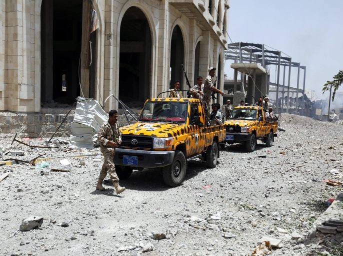 Armed members of the Houthi militia inspect properties allegedly damaged in an airstrike carried out by the Saudi-led coalition targeting two military bases controlled by Houthi fighters in Sanaa, Yemen, 20 April 2015. A huge explosion rocked Sana'a as airstrikes carried out by the Saudi-led coalition hit what witnesses said was a base used by a missile brigade of the Yemeni army, but is now controlled by the Houthis, the explosions damaging nearby civilian housing.