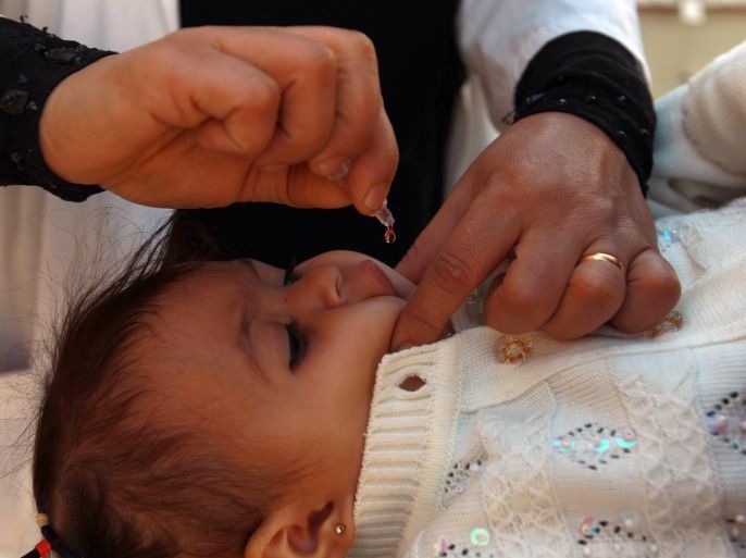 A Yemeni child receives a polio vaccination during a polio immunization campaign at a health center in Sanaa, on December 16, 2013. A three-day anti-polio immunization campaign to vaccinate more than four million children under five years old against polio began. The World Health Organisation and UNICEF have launched a polio vaccination campaign for 23 million children in the Middle East after 17 cases were discovered in Syria, they announced December 9. AFP PHOTO/ MOHAMMED HUWAIS