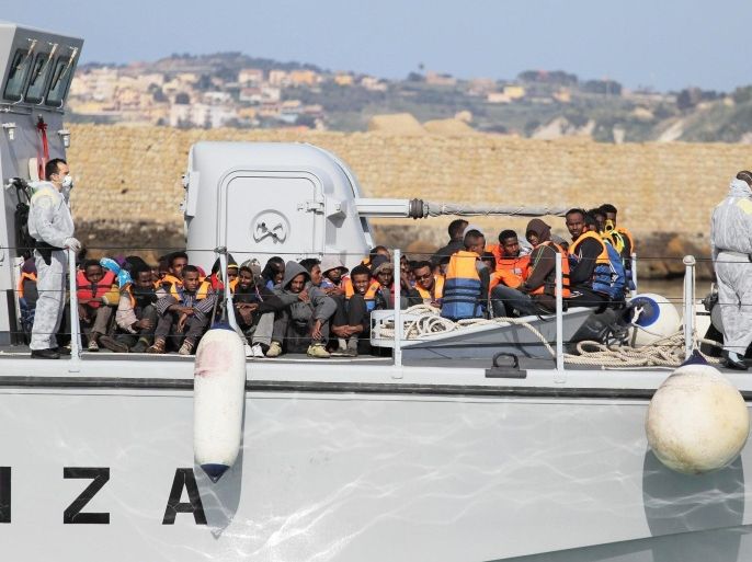 Rescued migrants disembark from an Italian Finance Guard vessel in Porto Empedocle, Sicily island, southern Italy, 12 April 2015. The body of one boat migrant and 1,739 survivors were picked up in several operations conducted over the past two days in the Mediterranean, Italian authorities said 12 April, adding that further sea rescues were ongoing.