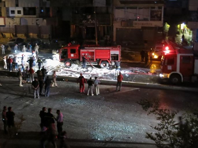 Civilians and security forces gather at the scene of a car bomb explosion in Baghdad's western district of Mansour, Iraq, Monday, April 27, 2015. A series of car bombings targeting busy commercial areas in Iraq's capital left many civilians killed and others wounded, officials said. (AP Photo)