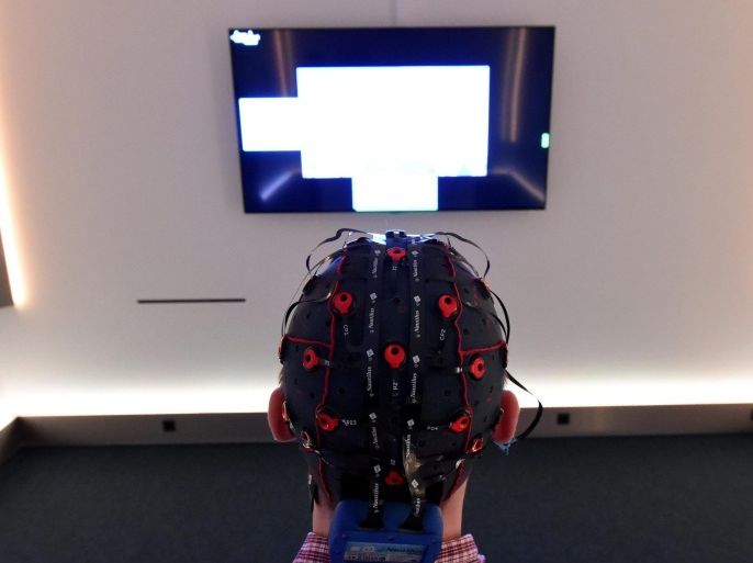 A picture made available on 11 April 2015 shows researcher Jens Reermann wearing a brain-computer interface allowing him to control pictures on a screen with his brain, at Christian-Albrechts-Universitaet in Kiel, Germany, 19 February 2015. Scientists are researching brain controlled technical devices for paralyzed people.