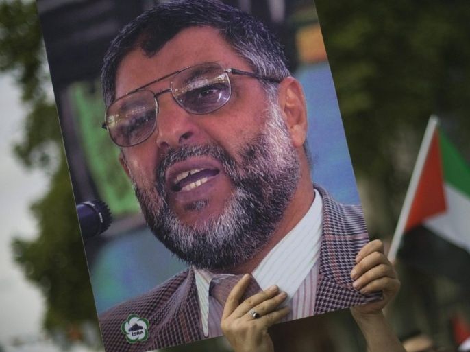 A demonstrator holds up a picture of late Hamas leader Abdel Aziz al-Rantissi during a rally to mark al-Quds (Jerusalem) day in Istanbul September 18, 2009.