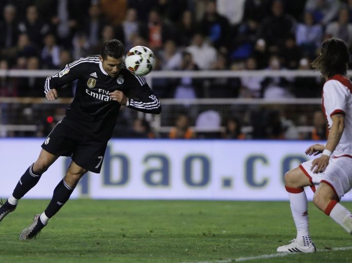 Real's Cristiano Ronaldo, left, scores during a Spanish La Liga soccer match between Rayo Vallecano and Real Madrid at the Vallecas stadium in Madrid, Spain, Wednesday, April 8, 2015. (AP Photo/Andres Kudacki)