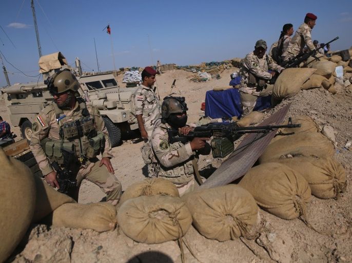 AL-KARMAH, IRAQ - APRIL 14: Iraqi Army troops take positions on the frontline with ISIL on April 14, 2015 near Al-Karmah, in Anbar Province, Iraq. Iraqi government forces are assaulting ISIL fighters on frontline positions which were established last year when ISIL captured much of the province.