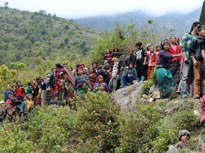 Nepalese villagers wait for relief aid from an Indian Army helicopter at Uiya village, in northern-central Gorkha district on April 29, 2015. Hungry and desperate villagers rushed towards relief helicopters in remote areas of Nepal, begging to be airlifted to safety, four days after a monster earthquake killed more than 5,000 people. AFP PHOTO / SAJJAD HUSSAIN