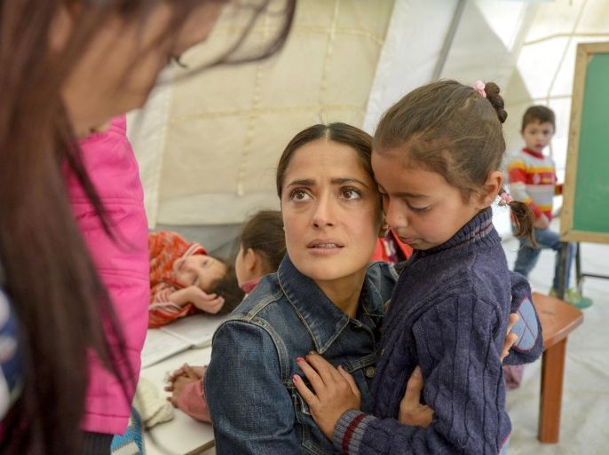 In This picture taken on Saturday April 25, 2015 and provided by UNICEF, Mexican-American actress Salma Hayek hugs a Syrian refugee girl Amira, who witnessed her father being killed in front of her by Islamic State fighters, during her visit to Saadnayz UNICEF protection center in the Bekaa Valley in Lebanon. Hayek is in Lebanon for the international premiere of the film, written and directed by Roger Allers, the maker of the Disney production The Lion King. The film tells the story of a young girl who finds the voice she lost through her friendship with a poet imprisoned for his ideas. (Sebastian Rich/UNICEF via AP)