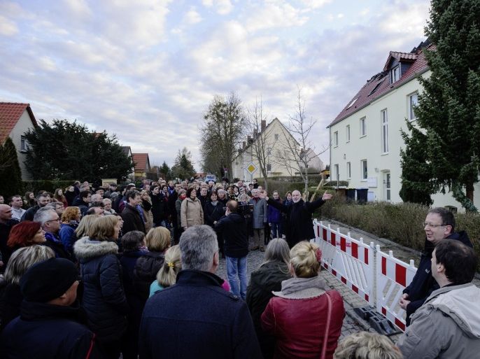 TROEGLITZ, GERMANY - APRIL 05: People gather to hold an evening vigil for peace to demonstrate against the recent arson attack against a facility for housing refugees on April 5, 2015 in Troeglitz, Germany. Troeglitz, a village with a population of 2,700, is scheduled to receive 40 refugees, though the move has divided the town and prompted gatherings in recent months of right-wing supporters that ultimately led to the resignation of Mayor Markus Nierth. Nierth, who supported receiving the refugees, claimed he feared for his family's safety. In the early hours of yesterday, unknown assailants tried to burn down the unoccupied facility. Germany, which in 2014 took in 200,000 refugees, is predicted to receive over 300,000 refugees in 2015, which in some areas, particularly in eastern Germany, is causing a popular backlash.