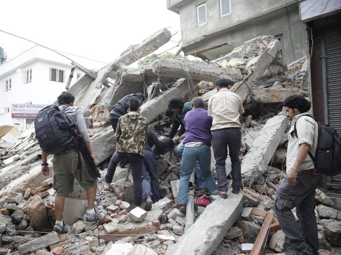People search for survivors in the rubble of a destroyed building after an earthquake hit Nepal, in Kathmandu, Nepal, 25 April 2015. A 7.9-magnitude earthquake rocked Nepal destroying buildings in Kathmandu and surrounding areas, with unconfirmed rumours of casualties. The epicentre was 80 kilometres north-west of Kathmandu, United States Geological Survey. Strong tremors were also felt in large areas of northern and eastern India and Bangladesh.