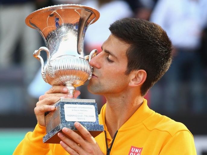 ROME, ITALY - MAY 17: Novak Djokovic of Serbia kisses the Winner's Trophy after his victory over Roger Federer of Switzerland in the Men's Singles Final on Day Eight of The Internazionali BNL d'Italia 2015 at the Foro Italico on May 17, 2015 in Rome, Italy.