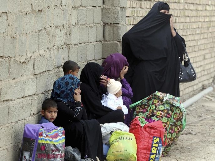 Internally displaced people who fled from Tikrit, Iraq, because they feared Islamic State militants settle at a refugee camp outside Baghdad, Iraq, Wednesday, March 18, 2015. (AP Photo/Karim Kadim)
