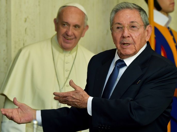 VATICAN CITY STATE : Cuban president Raul Castro (R) gestures in front of Pope Francis after their private audience at the Vatican on May 10, 2015. Cuban President Raul Castro arrived at the Vatican on Sunday to thank Pope Francis for his role in brokering the rapprochement between Havana and Washington. The first South American pope played a key role in secret negotiations between the United States and Cuba that led to the surprise announcement in December that they would seek to restore diplomatic ties after more than 50 years of tensions.